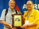 Carl Luetzelschwab, K9LA (L), receives the Bill Orr, W6SAI, Technical Writing Award from Central Division Director Dick Isely, W9GIG.